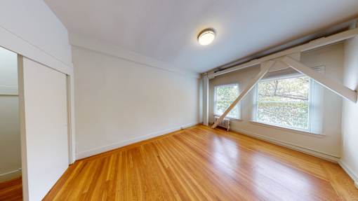 A room with wooden floors and white walls.