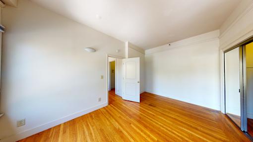 A room with wooden floors and white walls.