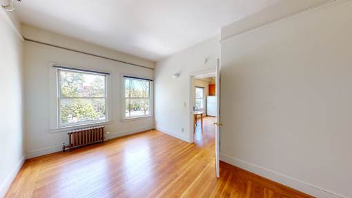 A room with wooden floors and white walls.