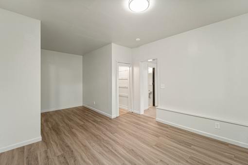 A room with white walls and wooden flooring.