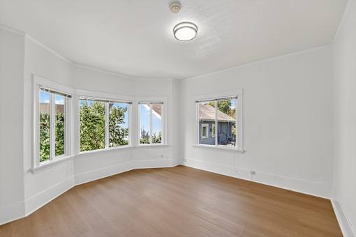 A room with wooden floors and white walls.