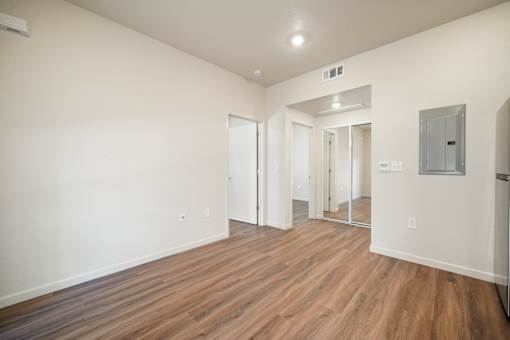 A room with wooden floors and white walls.
