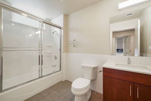 A white toilet sits next to a sink in a bathroom.