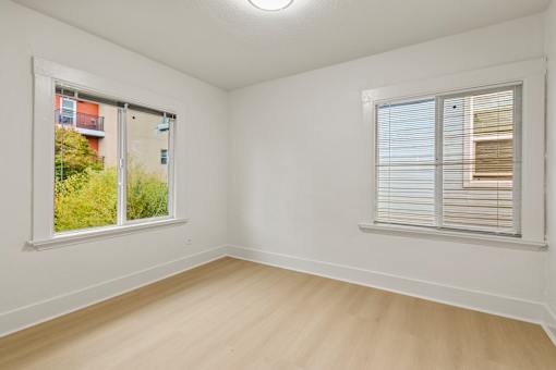 A room with a window on the right and a sliding glass door on the left.