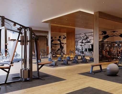 A gym with a variety of equipment including weights and exercise machines.
