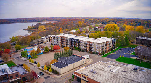 an aerial view of an apartment complex with a river in the background