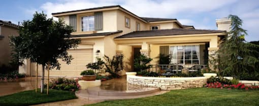a house with a fountain in the front yard