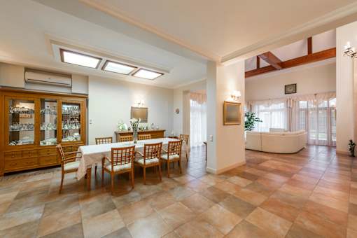 A dining room with a table set for six.