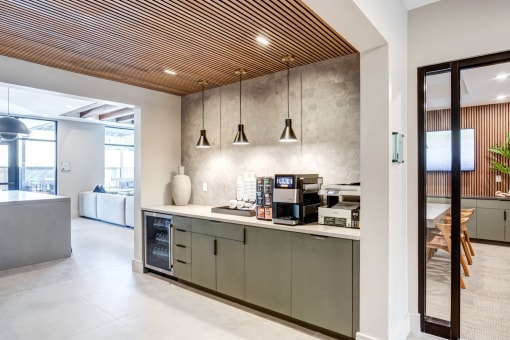 a kitchen with stainless steel cabinets and a counter with a coffee machine and a microwave