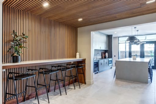the kitchen and dining area of a modern house with a large table and chairs