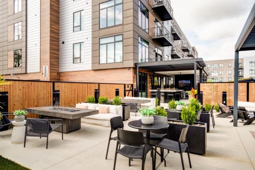 a patio with tables and chairs outside of a building