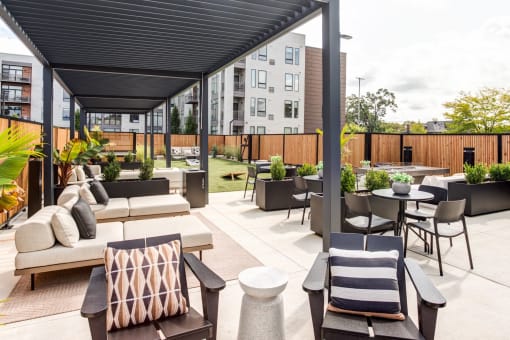 a rooftop patio with couches and tables and chairs