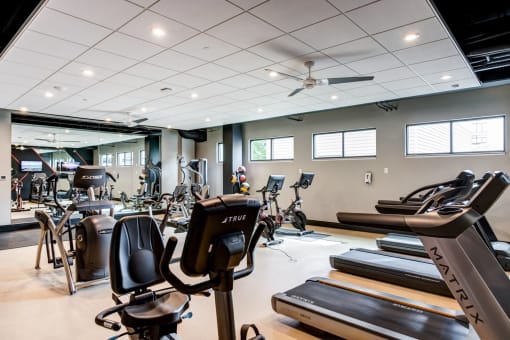 a gym with treadmills and other exercise equipment