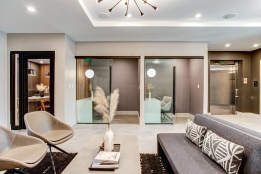 a living room with a couch and chairs and sliding glass doors