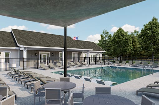 A poolside area with lounge chairs and a table at Solhaven Grand Chute, Wisconsin