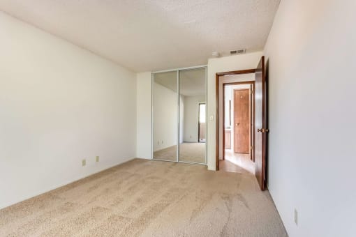 bedroom with mirrored closet doors