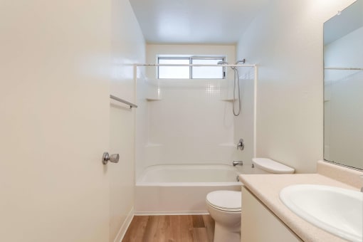bathroom with toilet, sink, and shower