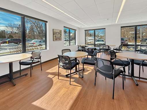 The Stryker Senior Apartments in West St. Paul Community Room room with a long table and chairs.