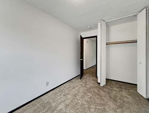 A room with a carpeted floor and white walls.