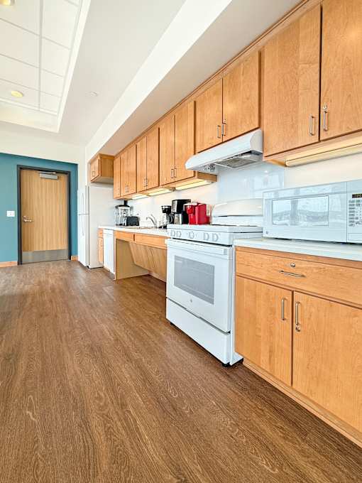 A kitchen with wooden cabinets and a white oven.