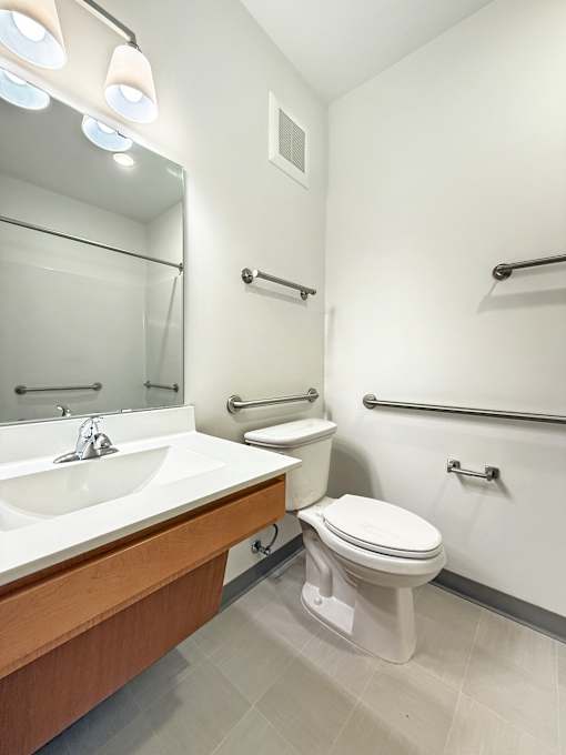 A white toilet sits next to a sink in a bathroom.