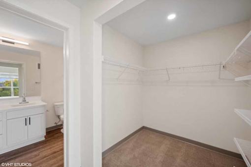 A white bathroom with a toilet, sink, and a window.