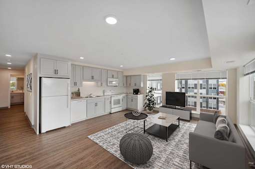 A modern kitchen with white appliances and a large island.