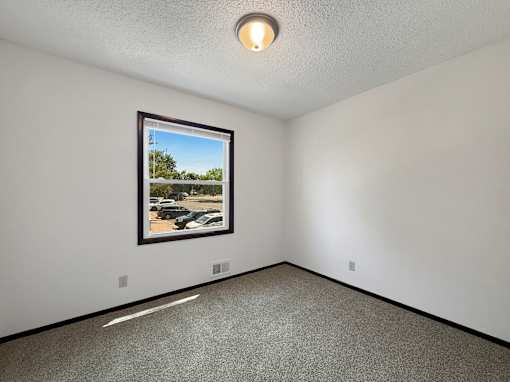 A room with a framed picture of a parking lot on the wall.