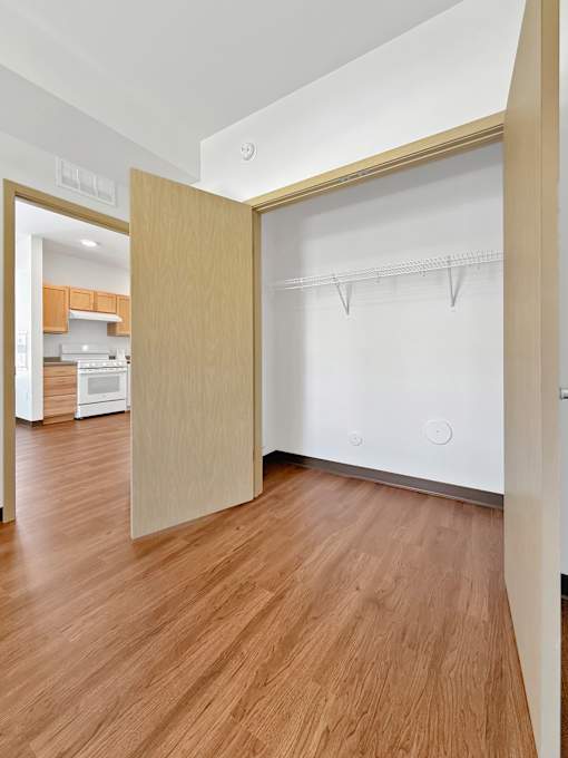 A Stryker Senior Apartments in West St. Paul spacious closet with a white shelf and a white door.
