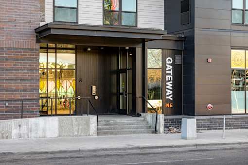 A building with a black door and a sign that says "GATEWAY NE".