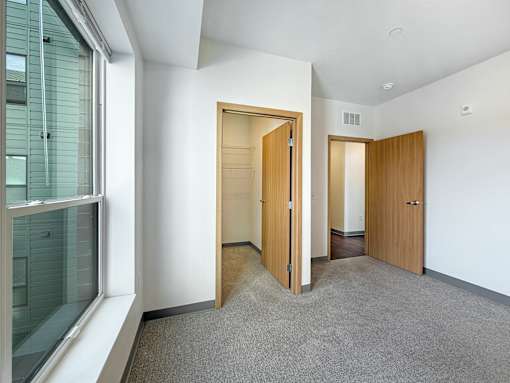 A room with two doors and a window.