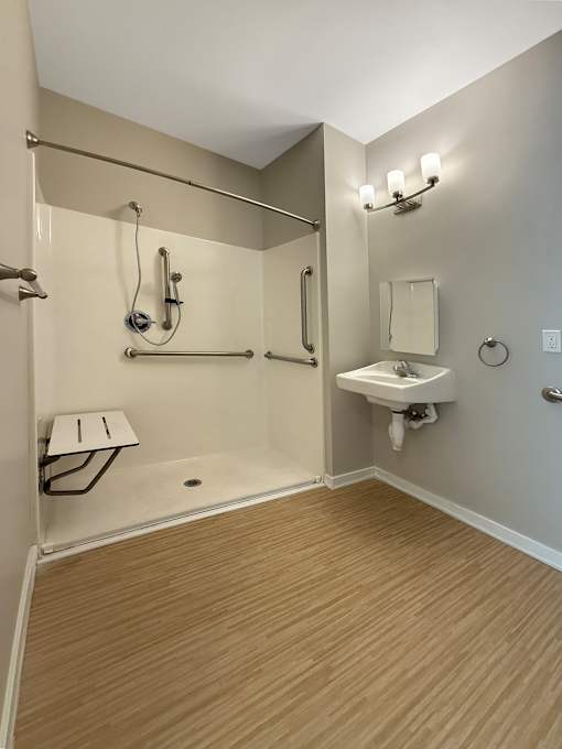 A bathroom with a walk-in shower and a sink.