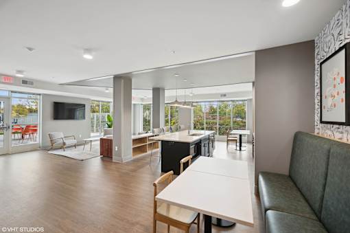 A modern living room with a dining table and chairs.