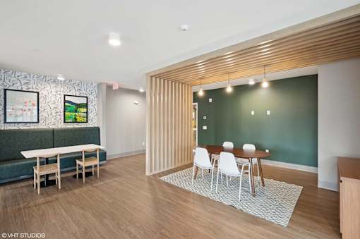 A room with a green wall and a wooden slat partition.