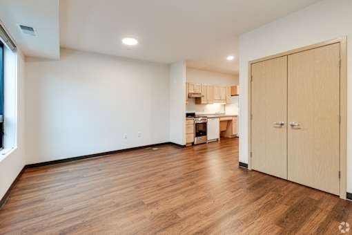 a Stryker Senior Apartments in West St Paul living room and kitchen with wood flooring and white walls