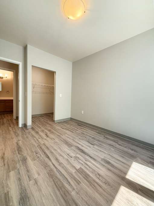 A room with a wooden floor and a light on the ceiling.