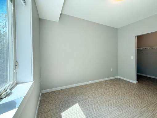 A room with a window and a door.