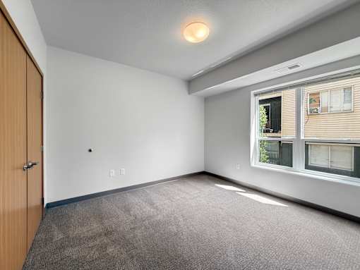 a bedroom with a large window