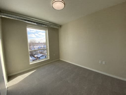 A room with a window showing a snowy landscape outside.