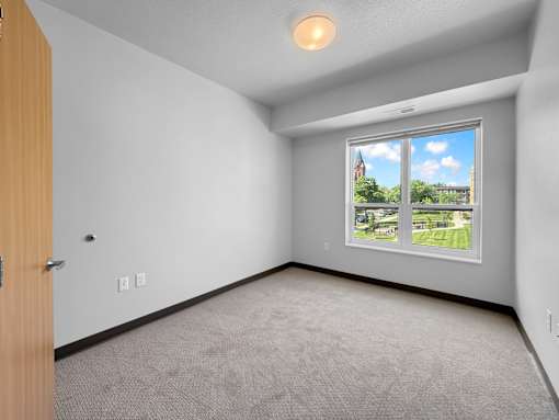a bedroom with a large window