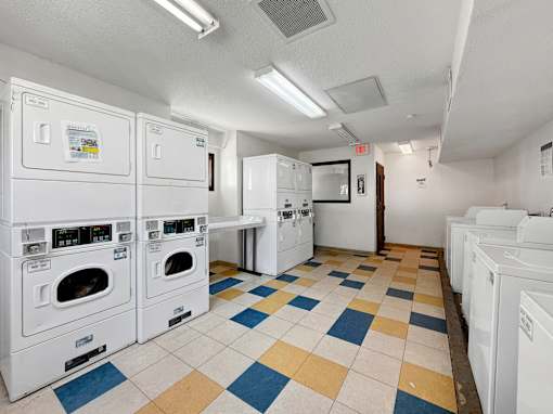 A laundry room with washers and dryers.