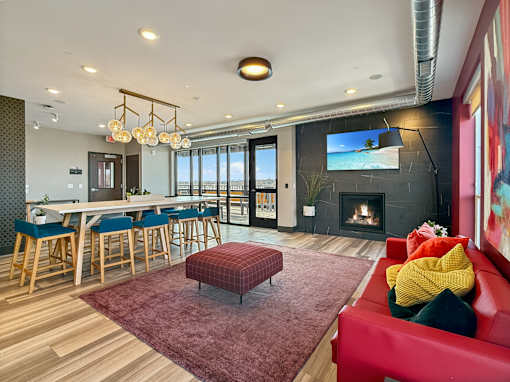 A modern living room with a red couch and a fireplace.
