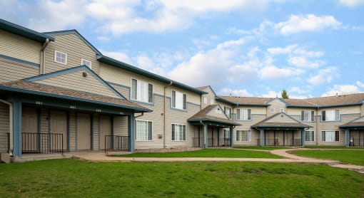 apartment building exterior with clouds and blue sky