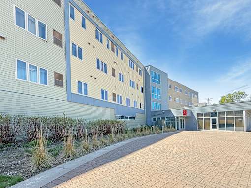 A modern building with a brick walkway in front.