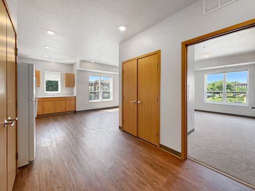 A hallway with a bedroom, closet