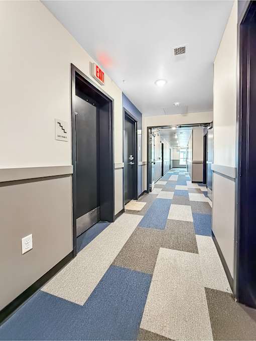 A long hallway with a blue and white checkered floor.