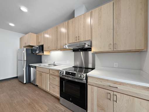 A kitchen with wooden cabinets and stainless steel appliances.