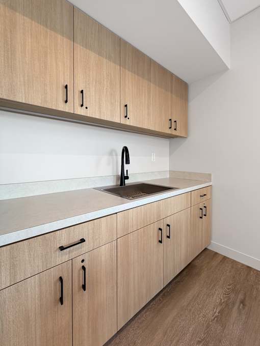A kitchen with wooden cabinets and a white countertop.