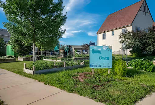 A sign in front of a building that says "Garden".