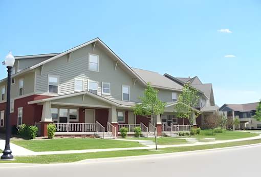 A row of townhouses with a street in front.